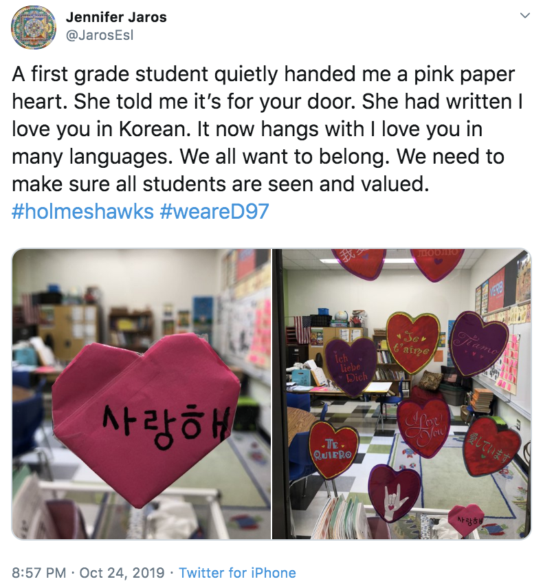 Photo: Tweet from Jennifer Jaros - "A first grade student quietly handed me a pink paper heart. She told me it's for your door. She had written I love you in Korean. It now hangs with I love you in many languages. We all want to belong. We need to make sure all students are seen and valued. #holmeshawks #weared97"
