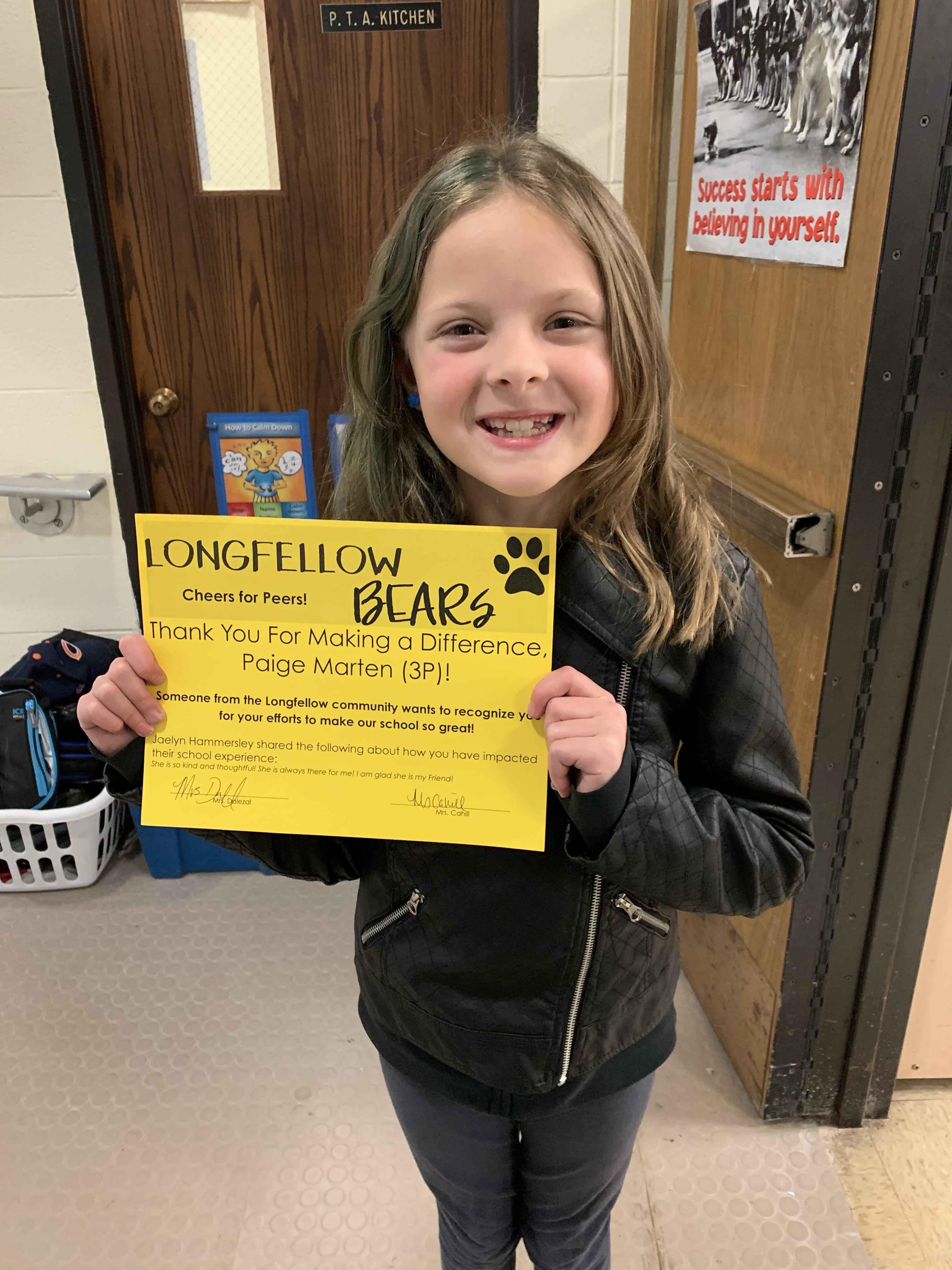 Student with "Cheers for Peers" certificate